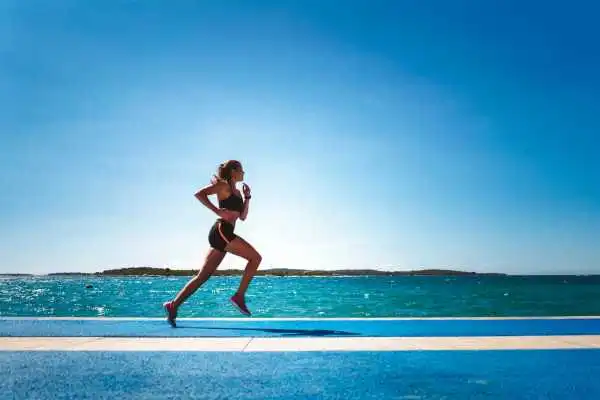 Woman running showing strong leg muscle Finchampstead